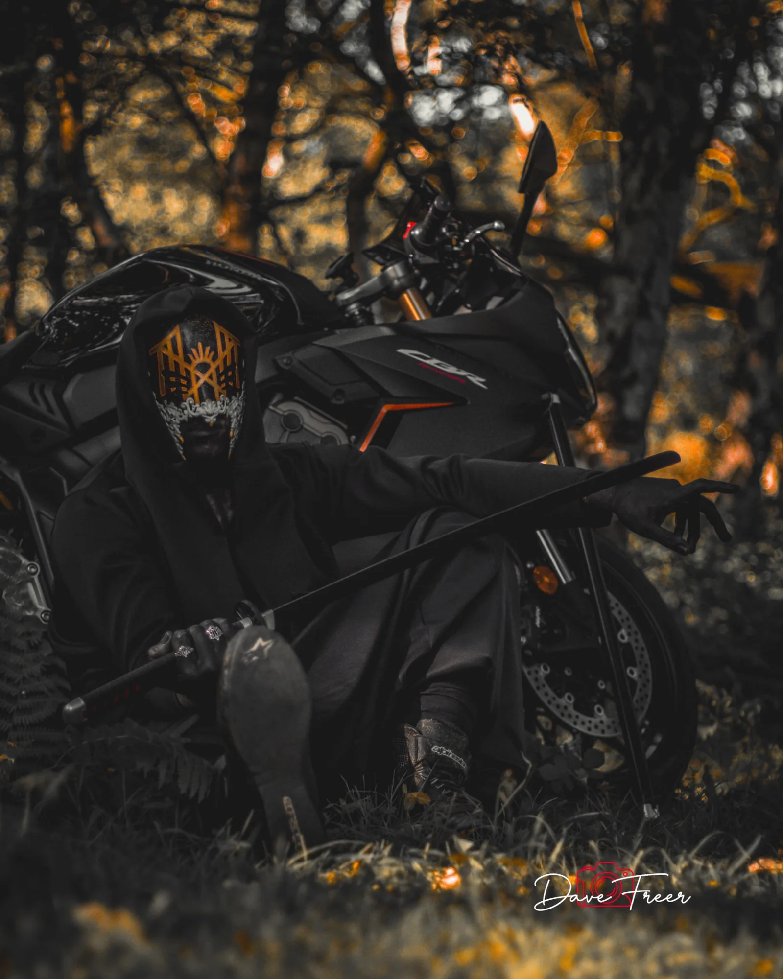 Dark cinematic motorcycle portrait in woodland