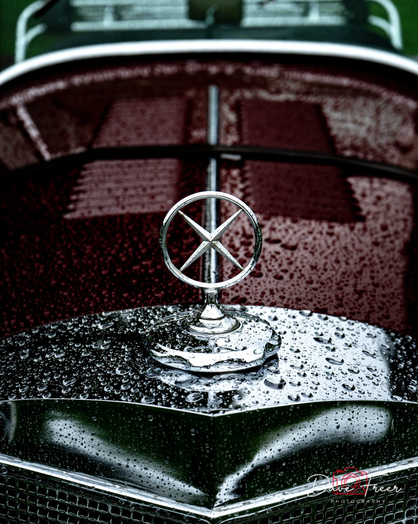 Classic car bonnet ornament covered in rain
